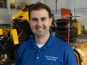 Man wearing a blue polo with the logo saying, 